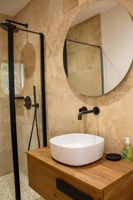 a bathroom with a white sink and a mirror at Villa A Calia di Fiori Mare in Sainte-Lucie de Porto-Vecchio