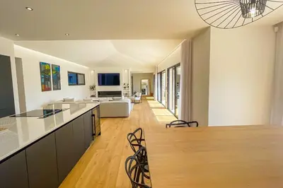 an open kitchen and living room with a long island at Villa A Calia di Fiori Mare in Sainte-Lucie de Porto-Vecchio