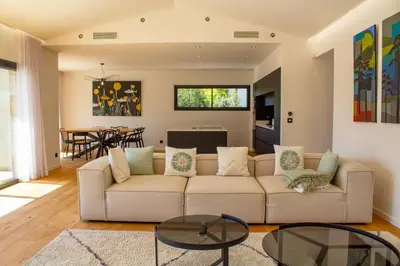 a living room with a couch and a table at Villa A Calia di Fiori Mare in Sainte-Lucie de Porto-Vecchio