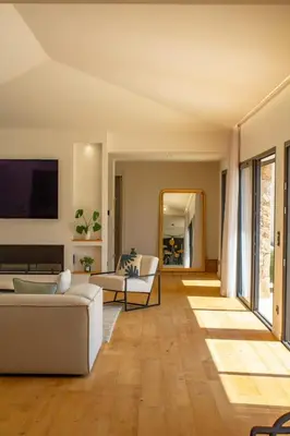 a living room with a couch and a tv at Villa A Calia di Fiori Mare in Sainte-Lucie de Porto-Vecchio