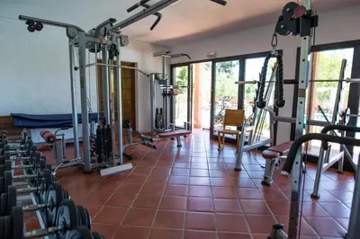 a gym with a bunch of equipment in a room at Royal Palm in Porto-Vecchio