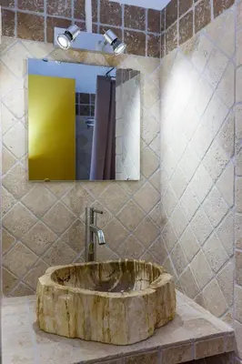 a bathroom with a wooden sink with a mirror at Royal Palm in Porto-Vecchio