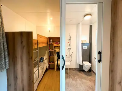 a small room with a bed and a bathroom at Campo Di Mare in Porto-Vecchio