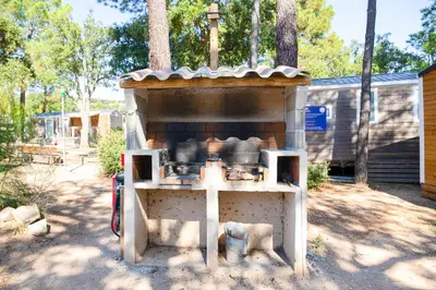 an outdoor oven with pots and pans in a yard at Campo Di Mare in Porto-Vecchio