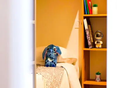 a stuffed dog sitting on top of a bed at Campo Di Mare in Porto-Vecchio