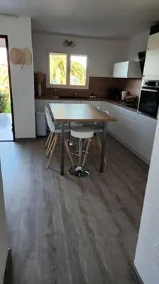 a kitchen with a table and chairs in a room at Mini villa Favone in Conca