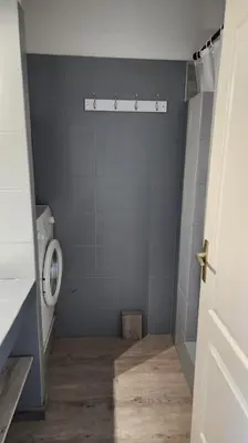 a bathroom with a toilet in a blue wall at Mini villa Favone in Conca