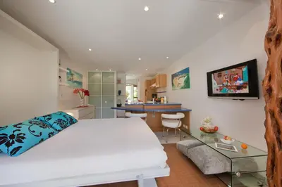 a bedroom with a white bed and a glass table at Studio Kalliste - Vision Luxe in Bonifacio