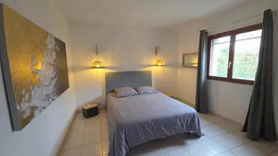 a bedroom with a bed with two pillows and a window at Maison agréable avec grands volumes in Levie