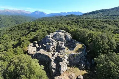 an aerial view of a rocky mountain with trees at Maison agréable avec grands volumes in Levie