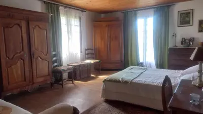 a bedroom with a bed and a dresser and windows at A casa di Francesca in Marignana