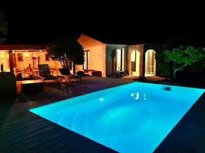 a swimming pool lit up at night at Casa Brahma pour 8 personnes -Porto Vecchio in San-Gavino-di-Carbini