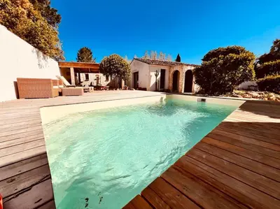 a swimming pool in the middle of a yard with a house at Casa Brahma pour 8 personnes -Porto Vecchio in San-Gavino-di-Carbini