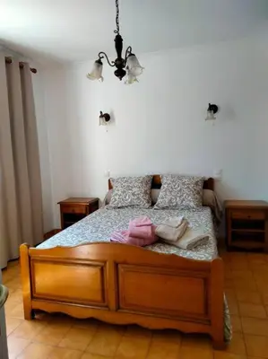 a bedroom with a bed and a window at Maison de village corse in Campitello