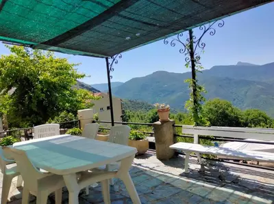 a view of a valley with mountains and trees at Maison de village corse in Campitello