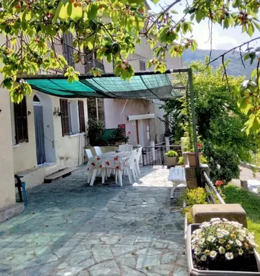 a bedroom with a wooden bed with towels on it at Maison de village corse in Campitello