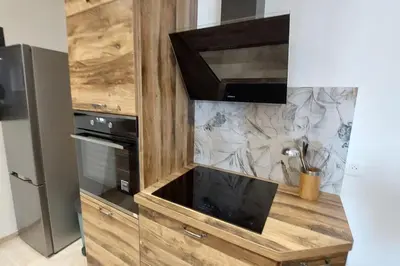 a wooden entertainment center with a flat screen tv at Bas de villa avec piscine in Moltifao