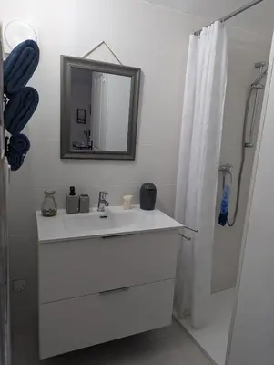 a white bathroom with a sink and a mirror at La chambre de Ptitruc au coeur du maquis in Granace