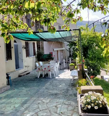 a bedroom with a bed and a window at Maison de village corse in Campitello