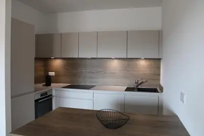 a kitchen with white cabinets and a sink at A Cardellina in Porticcio