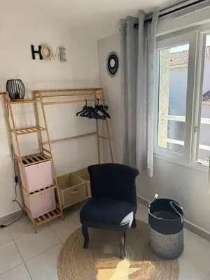 a living room with a chair and a window at Mini villa piscine et plage in Cervione