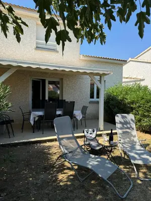two chairs and a table on a patio at Mini villa piscine et plage in Cervione