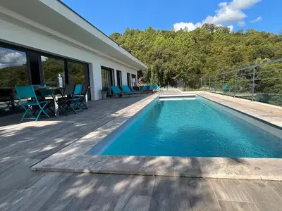 a swimming pool on a deck next to a house at a STELLA DI FOCE in Kamiesch