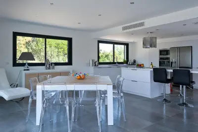 a kitchen and dining room with a table and chairs at a STELLA DI FOCE in Kamiesch