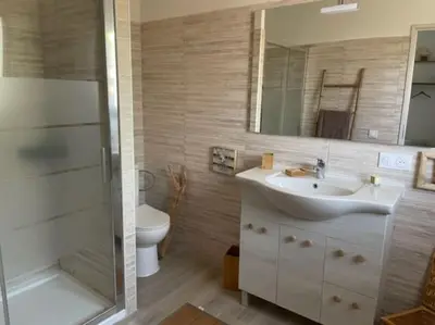 a bathroom with a sink and a shower and a toilet at Villa à Cala-Rossa,Porto-Vecchio proche des plages in Le Ranch