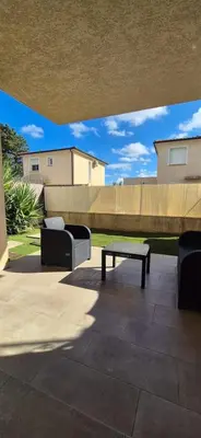 a patio with a bench and a table and a fence at Charmant appartement in Borgo