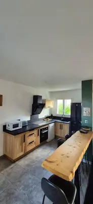 a kitchen with a wooden table and a wooden counter top at Charmant appartement in Borgo