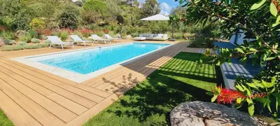 a swimming pool in a yard with chairs around it at Villa Alba, 8 pers, piscine chauffée, 5 minutes plage in Cirendinu