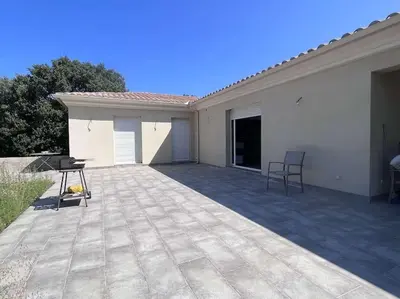 a large living room with a table and a kitchen at Casalea in Oletta