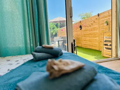 a bed with blue pillows in a room with a window at Casa Tania in Borgo