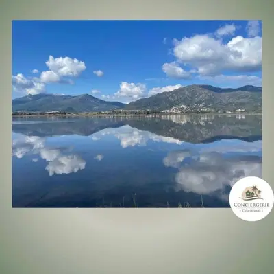 a picture of a lake with clouds in the water at Casa Tania in Borgo