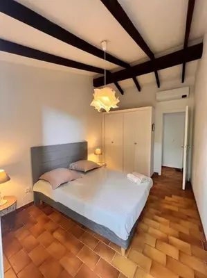a bedroom with a large bed in a room at Logement Mésange600m à pied de SantaGiulia Jacuzzi in Porto-Vecchio