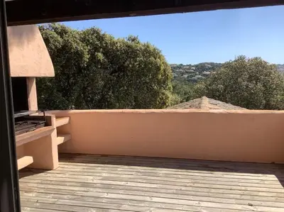 a view of a patio with a fence and trees at Logement Mésange600m à pied de SantaGiulia Jacuzzi in Porto-Vecchio