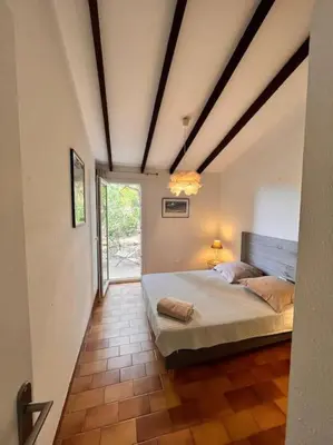 a bedroom with a large bed in a room at Logement Mésange600m à pied de SantaGiulia Jacuzzi in Porto-Vecchio