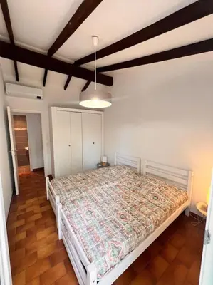 a bedroom with a large bed in a room at Logement Mésange600m à pied de SantaGiulia Jacuzzi in Porto-Vecchio