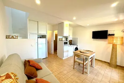 a living room with a couch and a table at Adorable duplex vue mer 5 min à pied de Santa Giulia in Porto-Vecchio