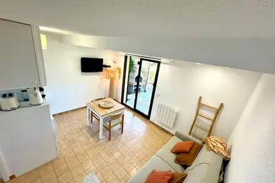 a living room with a couch and a table at Adorable duplex vue mer 5 min à pied de Santa Giulia in Porto-Vecchio