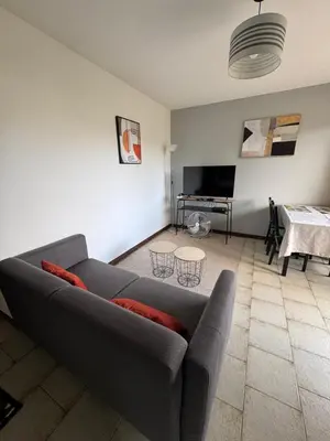 a living room with a couch and a table at Vacances AJACCIO in Ajaccio