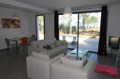a living room with a white couch and a television at Résidence Isola Hotel in Borgo
