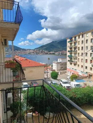a view of the water from a balcony of a building at Chambres chez l'habitant in Ajaccio
