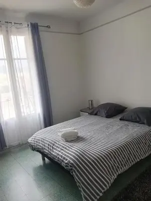 a bedroom with a bed with a pillow on it at Chambres chez l'habitant in Ajaccio