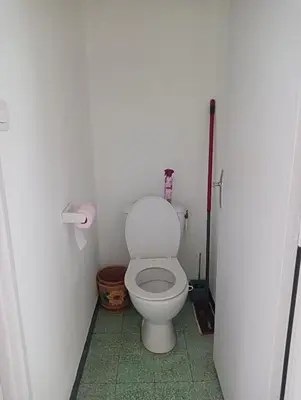 a bathroom with a white toilet in a stall at Chambres chez l'habitant in Ajaccio