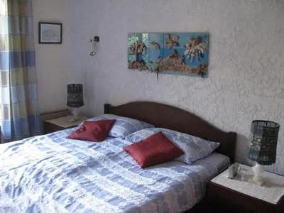 a bed with two pillows on it in a bedroom at Villa Nitiola Plage de Palombaggia in Bocca del Oro