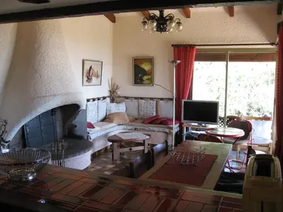 a living room with a couch and a fireplace at Villa Nitiola Plage de Palombaggia in Bocca del Oro