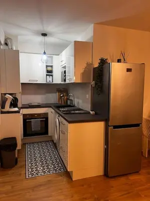 a kitchen with a refrigerator and a stove top oven at CASA NINA FURIANI CORSE Appartement en résidence in Paterno