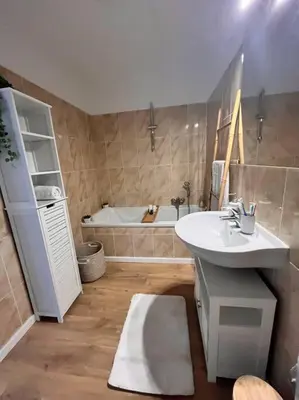 a bathroom with a sink and a bath tub at CASA NINA FURIANI CORSE Appartement en résidence in Paterno